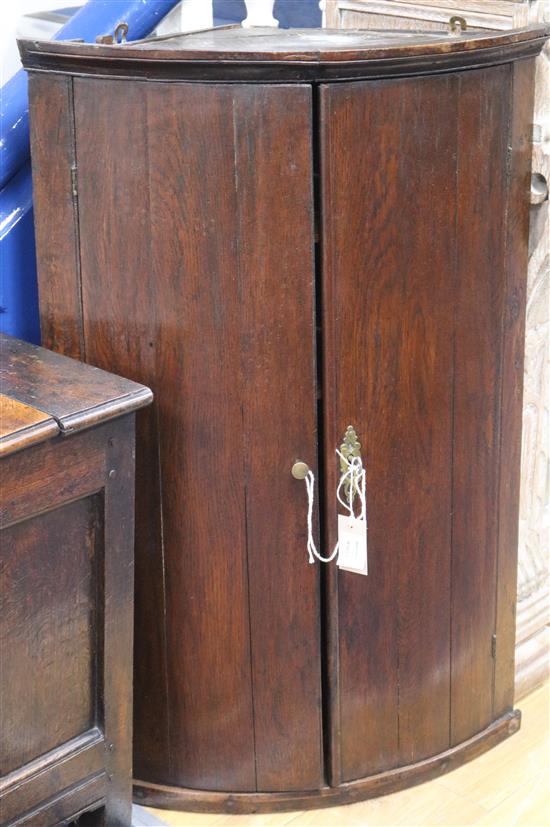 A mid 18th century oak corner cupboard W.60cm